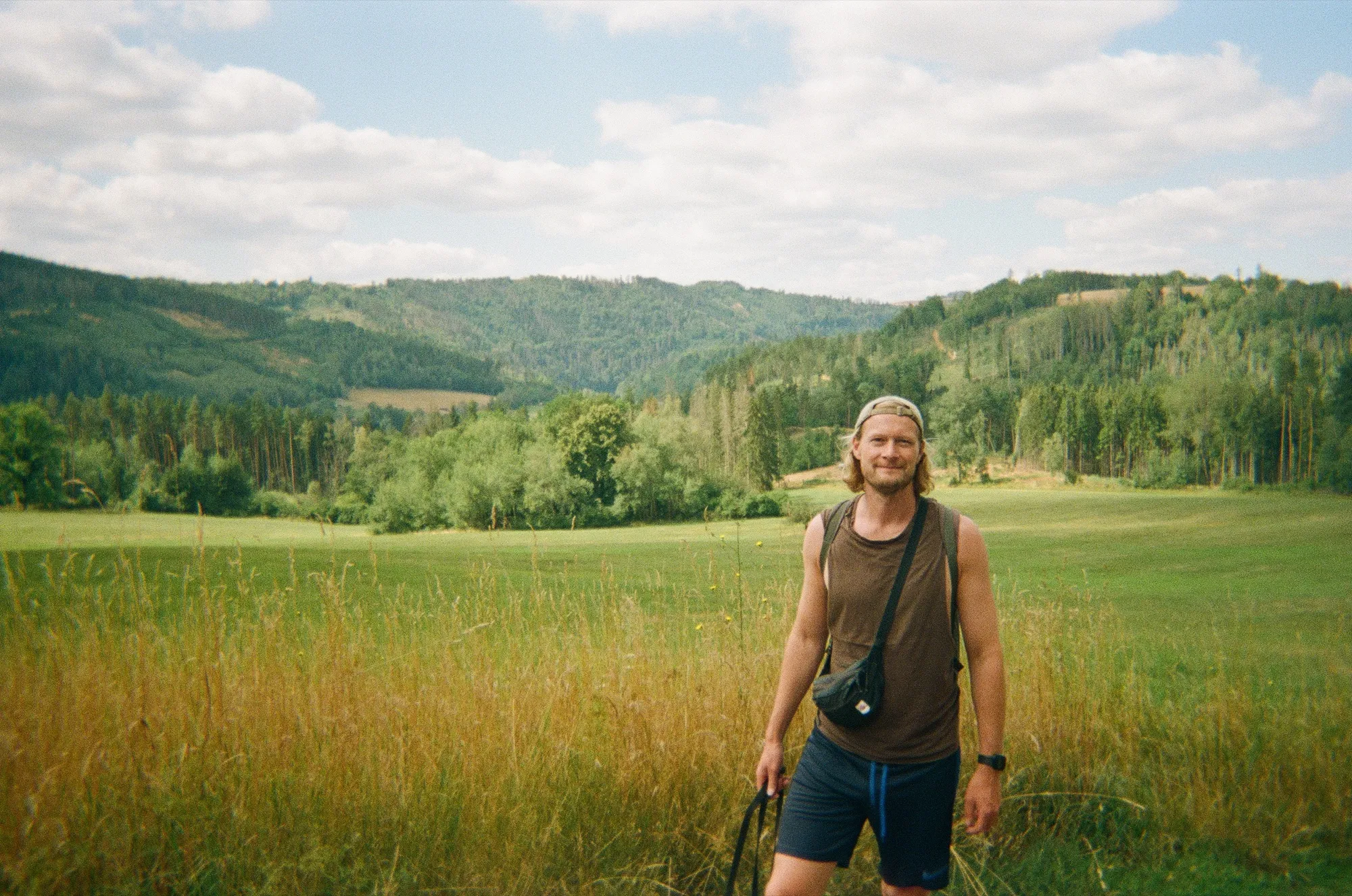 Julian Bendtsen hiking in a green landscape